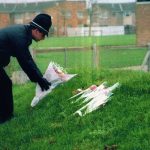 A police officer lays flowers in tribute to Rikki in 1994